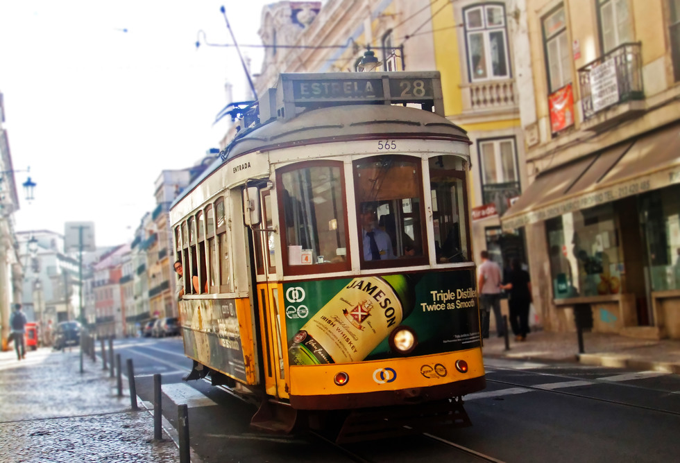 Tram 28 careens up a Lisbon street