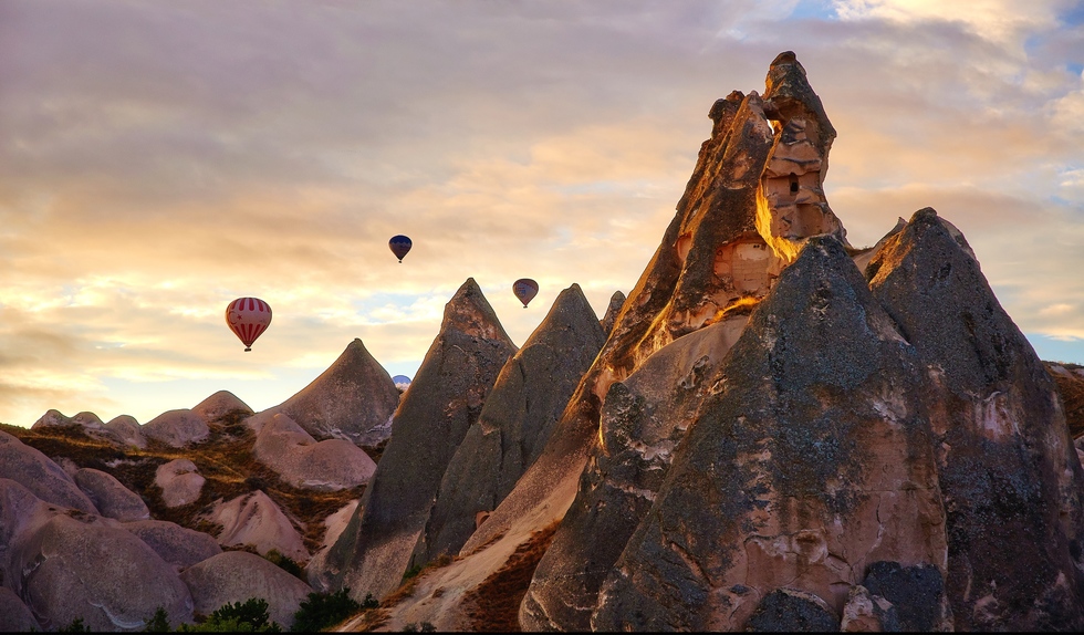 Balloons drift over the Goreme Valley in Turkey