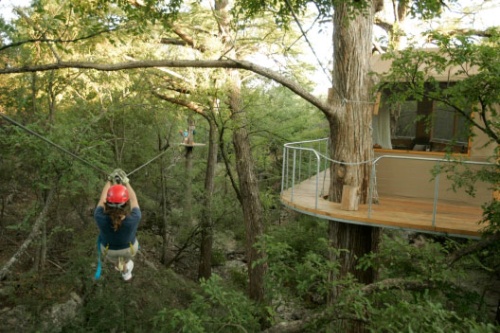 A guest zips past the Lofthaven at Cypress Valley Canopy Tours outside Austin, Texas. Photo by Erich Schlegel / Cypress Valley Canopy Tours