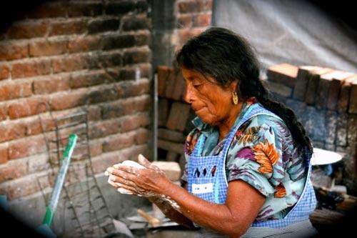 A woman makes tortillas in Oaxaca, Mexico.