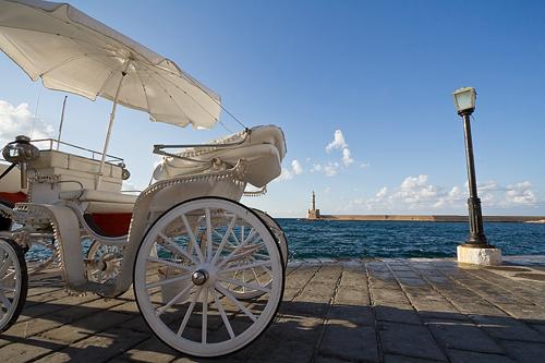 White carriage waiting for passengers in the old harbor of Chania, Crete