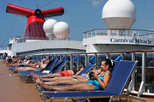 Sunbathers on the lido deck aboard Carnival Miracle. Photo: Carnival Cruise Lines